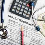 Health care costs. Stethoscope and calculator symbol for health
